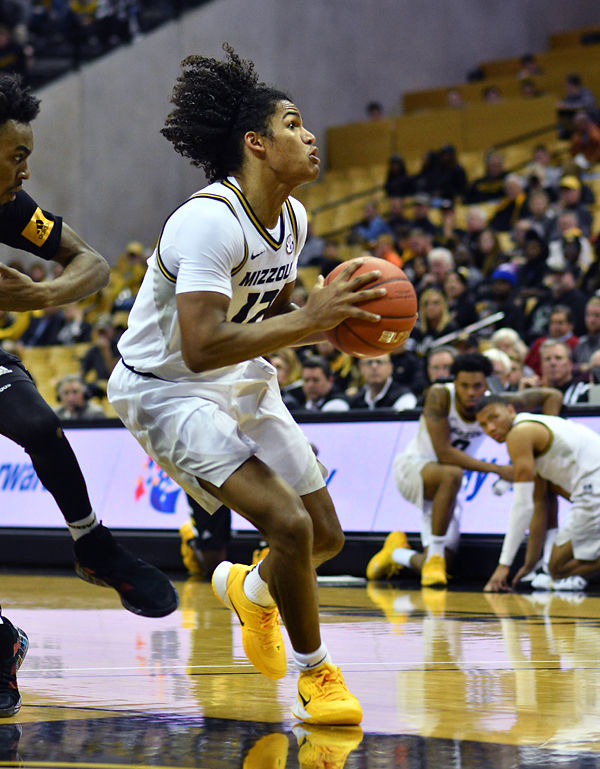 Dru Smith spins around the defense